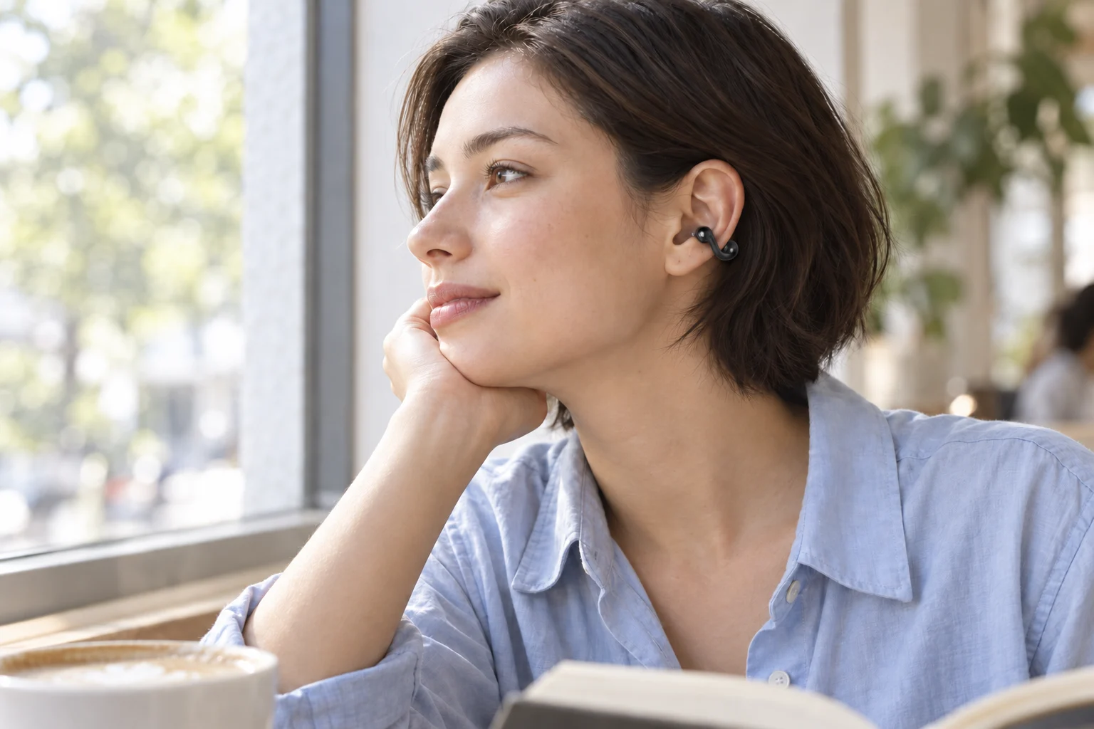 Illustrated cafe listening scene with an open-ear cuff